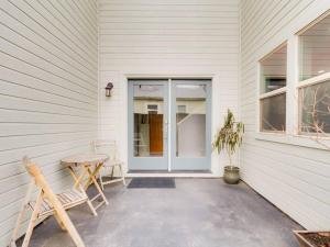 a porch with a table and chairs and a door at Brand New Downtown Modern 5 Beds, 3 Full Baths Vermont Avenue, Boise in Boise