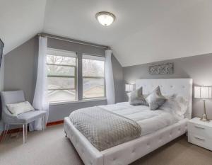 a white bedroom with a large bed and a window at Brand New Downtown Modern 5 Beds, 3 Full Baths Vermont Avenue, Boise in Boise