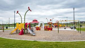 a park with a playground with slides and swings at Vinash Luxury Suite in Edmonton