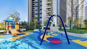 an empty playground with swings and a slide at Sea View Apartment with Washer Dryer Projector Refrigerator and Kitchen Shantou South High-Speed Railway St ation in Shantou