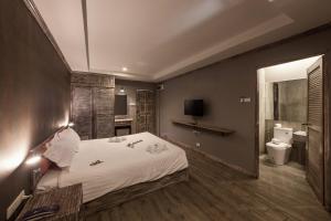 a bedroom with a large bed and a bathroom at JALMIN Hotel Samui in Koh Samui