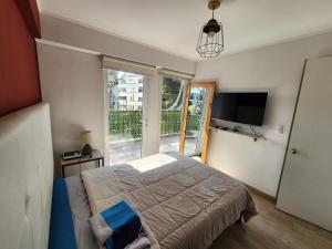 a bedroom with a bed and a large window at Departamento en barranco 2 in Lima