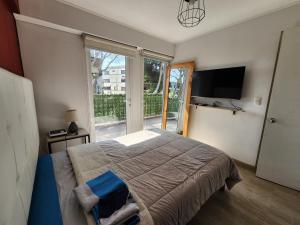 a bedroom with a large bed and a large window at Departamento en barranco 2 in Lima