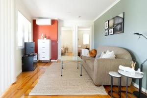 a living room with a couch and a table at Sunset Meadows in Sunset Strip