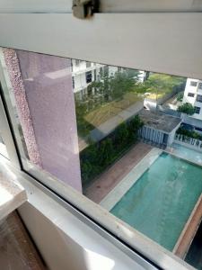 a view of a swimming pool from a window at Reen's Cosy Place in Cyberjaya