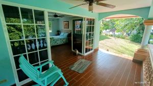a living room with a blue chair and a bedroom at Villas at Gone Fishing Panamá Resort in Boca Chica