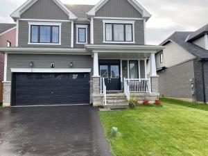 a gray house with a black garage at Spacious,comfy house,less than 15 mins to Niagara Falls in Thorold