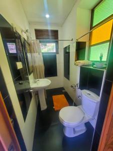 a bathroom with a toilet and a sink at Resort Beam in Kandy