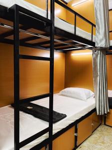 a bunk bed room with two bunk beds in a room at The Comb Hanoi Hostel in Hanoi