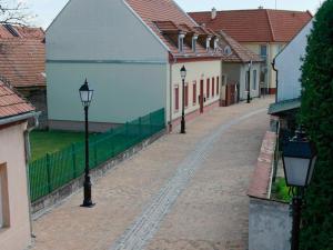 a cobblestone street with street lights and buildings at Citylife Rooms in Mosonmagyaróvár