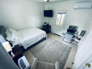 a small bedroom with a bed and a kitchen at Holistic Gem w/1Gig Wi-Fi & free parking in Houston