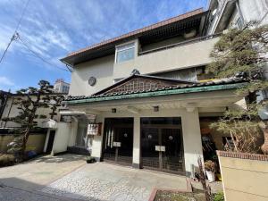 a building with the front door of a building at Masuya Ryokan in Nozawa Onsen