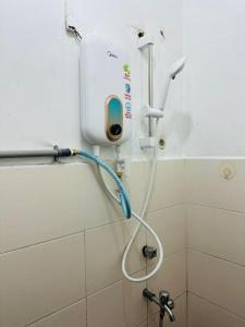 a shower in the corner of a bathroom at 3BR MINIMALIST Homestay NEAR KKIA Cyber City in Kapayan