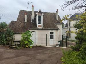 a white house with a fence in front of it at MAISON VENEUX LES SABLONS-FONTAINEBLEAU-MORET SUR LOING in Veneux-les-Sablons