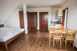 a bedroom with a bed and a table and chairs at Apartmány Chajdovka in Boží Dar