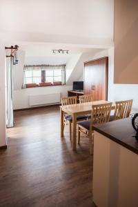 a dining room with a table and chairs at Apartmány Chajdovka in Boží Dar