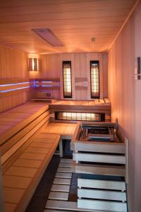 a japanese sauna with wooden floors and benches at Apartmány Chajdovka in Boží Dar