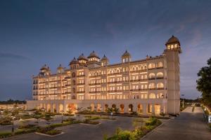 a large white building with a lot of windows at Uday Palace Navsari, a member of Radisson Individuals in Navsāri