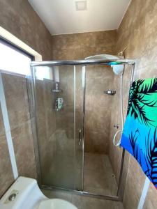 a shower stall in a bathroom with a toilet at Hermoso departamento con piscina en la playa in Playas