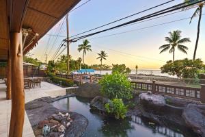 a view of the beach from a resort with a pond at Seahorse Luxury Suite at Seaspray Oceanview in Kailua-Kona