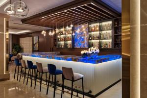 een bar in de lobby van het hotel met blauwe stoelen bij Crowne Plaza Tashkent, an IHG Hotel in Tasjkent