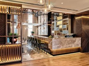 a lobby with a bar with stools at Crowne Plaza Tashkent, an IHG Hotel in Tashkent