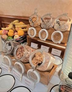 a display of different types of food in glass jars at Hotel Mirabeau, BW Signature Collection, Lausanne in Lausanne