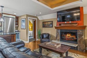 a living room with a couch and a fireplace at Rockies Retreat by Canadian Rockies Vacation Rentals in Canmore