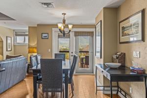 a dining room and living room with a table and chairs at Rockies Retreat by Canadian Rockies Vacation Rentals in Canmore