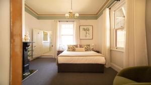 a bedroom with a bed and a window at Isabellas At Beechworth in Beechworth