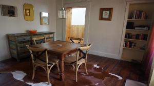 a dining room with a wooden table and chairs at Gladstone House in Beechworth