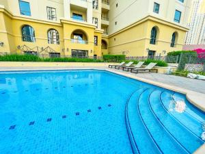 a large swimming pool in front of a building at MURJAN JBR Apartments by HAPPY SEASON in Dubai