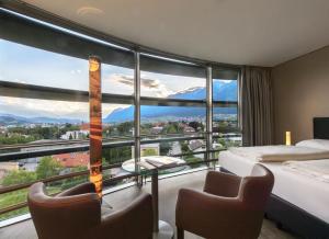 a hotel room with a large window with a view at Parkhotel Hall in Tirol in Hall in Tirol