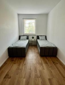 a room with two beds and a window at Apartament Przytulny 3, self check in, parking in Rzeszów