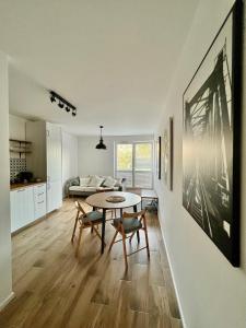a kitchen and living room with a table and chairs at Apartament Przytulny 3, self check in, parking in Rzeszów