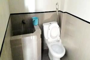 a small bathroom with a toilet in a stall at OYO Life 92647 Edelweis Homestay in Tuban