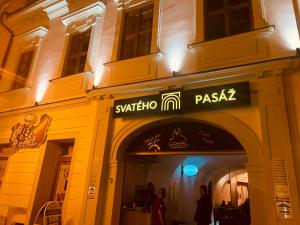 a store with a sign on the side of a building at Svatého Pasáž BOUTIQUE Apartments with free parking in Trnava