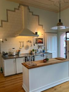 a kitchen with white cabinets and a counter top at Altbauwohnung in Gründerzeitvilla in Wuppertal