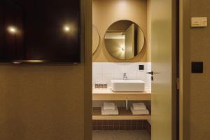 a bathroom with a sink and a mirror at Hôtel de Noailles in Lyon