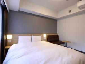 Ένα ή περισσότερα κρεβάτια σε δωμάτιο στο Dormy Inn Hiroshima Annex