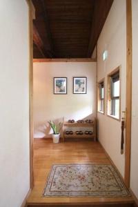 a hallway of a house with a rug on the floor at 南阿蘇Villagehouseらかん in Minami Aso