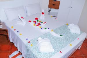 a bed with white shoes and flowers on it at Dahab Lagoon Club & Resort Ex Tirana Dahab in Dahab