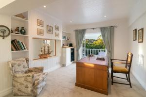 a living room with a desk and a chair at The Knysna Belle Guest House in Knysna