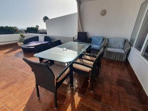 a room with a table and chairs and a couch at Island Village in Adeje