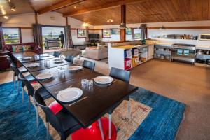 a dining room and living room with a table and chairs at Skotel Alpine Resort in Whakapapa Village