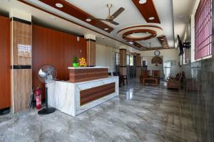 a lobby with a reception desk in a building at Selva Inn in Puducherry