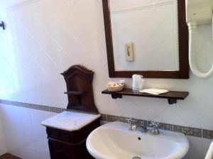 a bathroom with a sink and a mirror at Agriturismo La Cavaliera in Monteveglio +33 photos