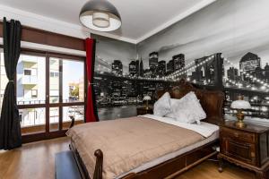 a bedroom with a bed with a city mural on the wall at The whole villa, near a large park and a quiet beach in Barreiro