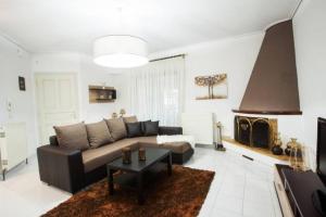 Una sala de estar con un sofá y una chimenea. en Sweet Dreams Trikala, en Tríkala