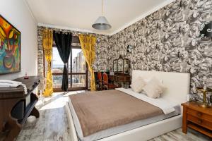 Schlafzimmer mit einem Bett, einem Schreibtisch und einer Wand in der Unterkunft The whole villa, near a large park and a quiet beach in Barreiro